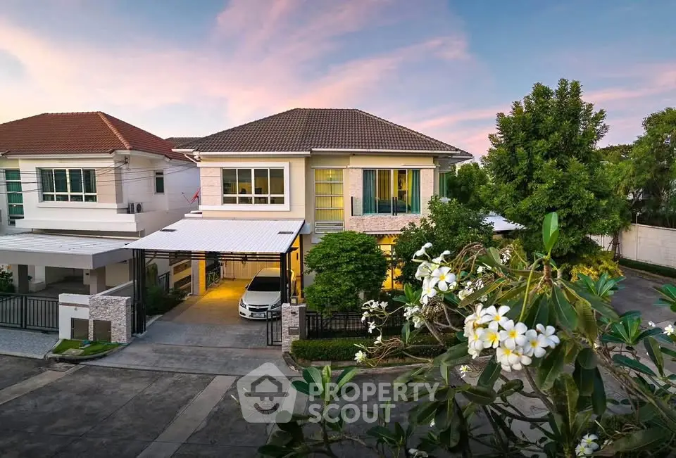 Charming suburban house with lush garden and driveway at sunset, perfect family home.
