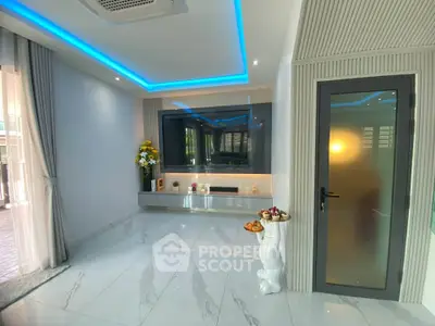 Modern living room with sleek design, LED lighting, and large TV setup.
