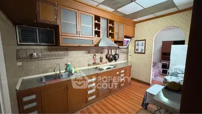 Charming kitchen with wooden cabinets and modern appliances in cozy home setting.