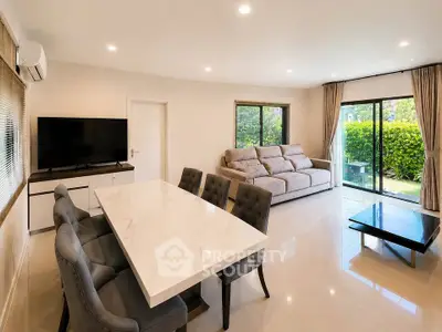 Spacious modern living room with elegant dining area and garden view