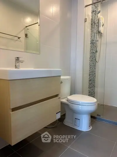 Modern bathroom with sleek fixtures and glass shower enclosure