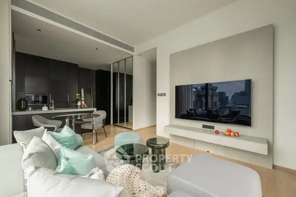 Modern living room with sleek kitchen and large TV, perfect for urban living.