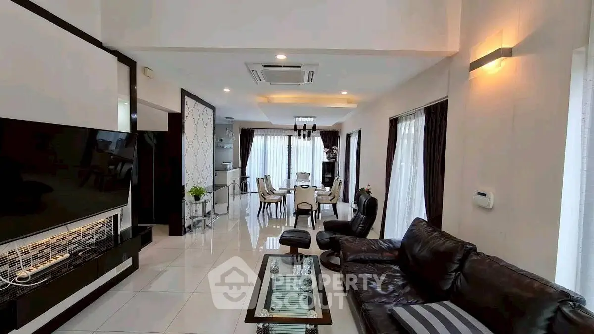 Luxurious modern living room with elegant decor and spacious dining area, perfect for stylish living.