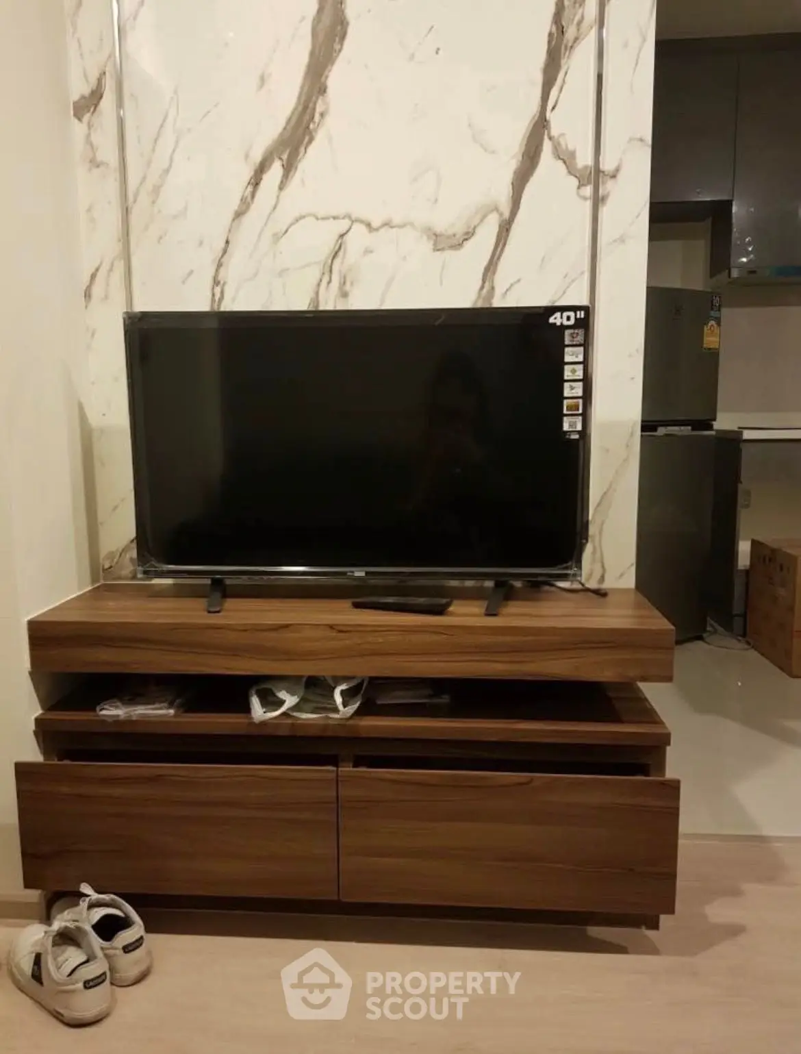 Modern living room with stylish TV stand and marble accent wall