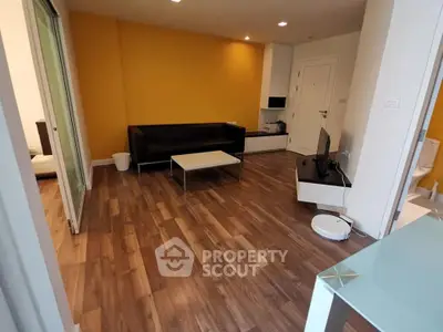 Modern living room with yellow accent wall and sleek furniture