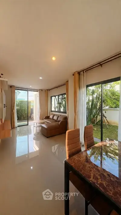 Spacious living room with garden view and elegant dining area in modern home