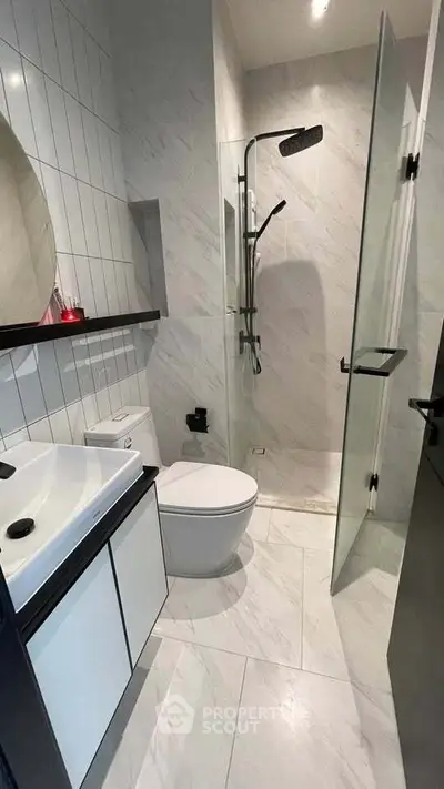 Modern bathroom with sleek shower and contemporary fixtures in stylish apartment.