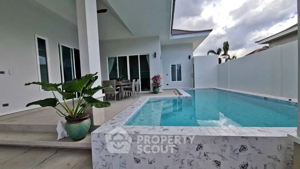 Luxurious modern home with private pool and spacious patio area, perfect for relaxation and entertainment.