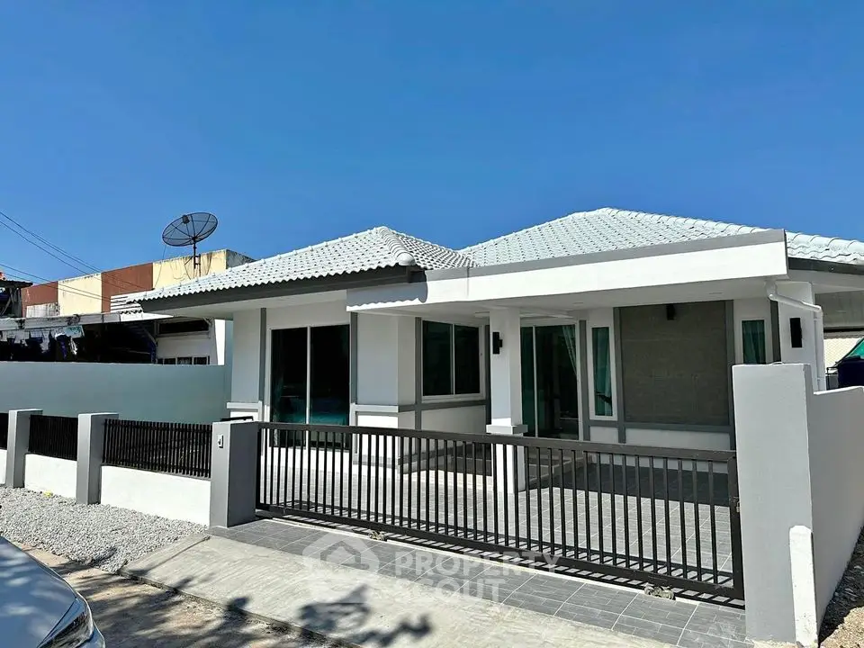 Charming single-story house with modern design and spacious front yard in a serene neighborhood.