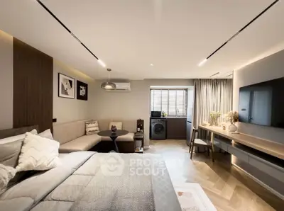 Modern bedroom with cozy seating area and in-room washing machine