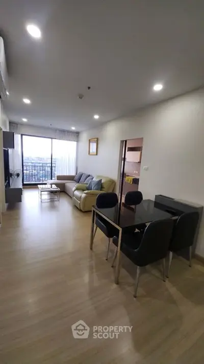 Spacious modern living room with large windows and stylish furniture, offering a cozy and inviting atmosphere.