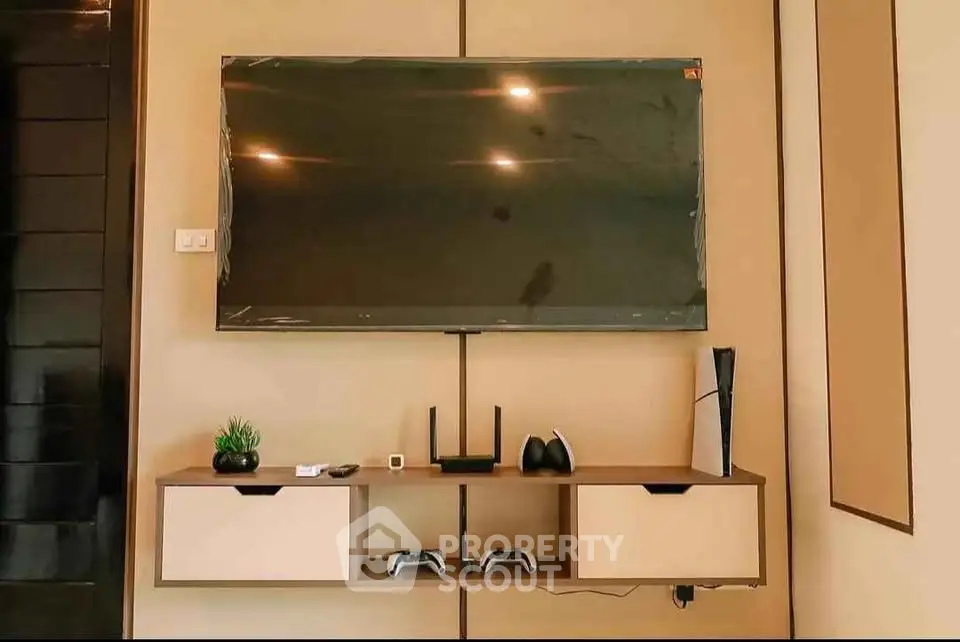 Modern living room with wall-mounted TV and sleek entertainment console