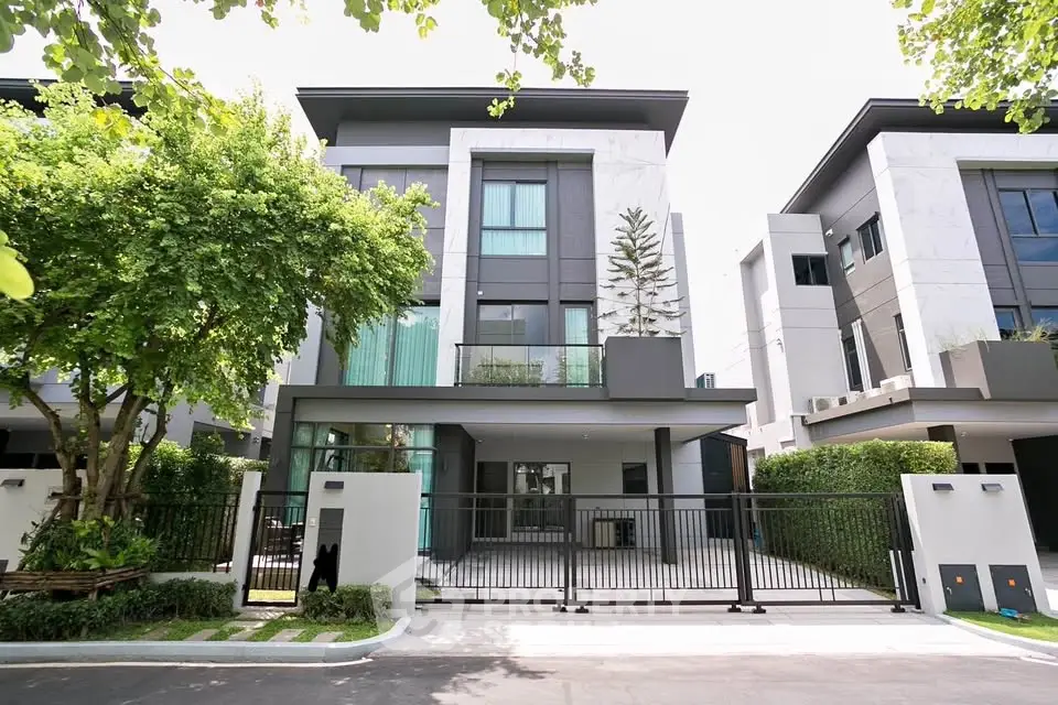 Modern luxury townhouse with sleek design and lush greenery in a serene neighborhood.