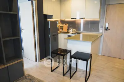Modern kitchen with sleek cabinetry and breakfast bar in a stylish apartment