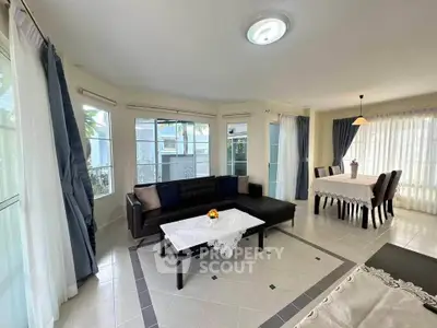 Spacious living and dining area with elegant decor and natural light