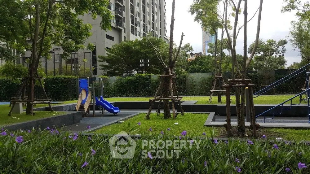 Modern apartment building with lush garden and playground area