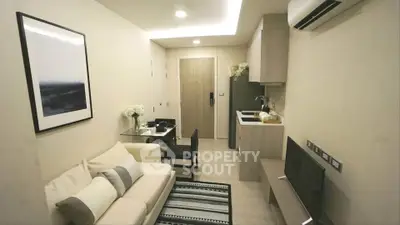 Modern compact living room with stylish decor and open kitchen layout