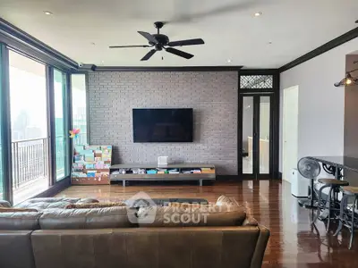 Spacious living room with modern decor and city view balcony, perfect for urban living.