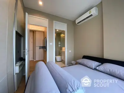 Modern bedroom with ensuite bathroom and air conditioning in luxury apartment