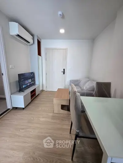 Modern living room with sleek furniture and air conditioning in a cozy apartment.