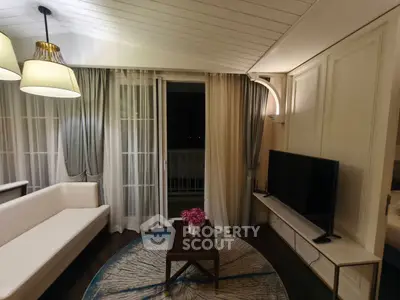 Elegant living room with modern decor and large windows opening to a balcony.