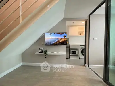 Modern interior with under-stair TV setup and laundry area, sleek design