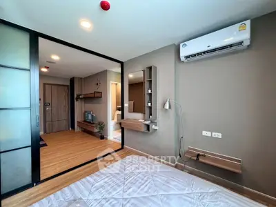 Modern bedroom with sliding glass doors and air conditioning in a stylish apartment.