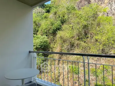 Charming balcony with lush green view, perfect for relaxation and enjoying nature's tranquility.