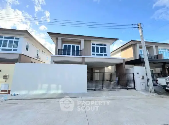 Modern two-story house with spacious driveway and contemporary design.