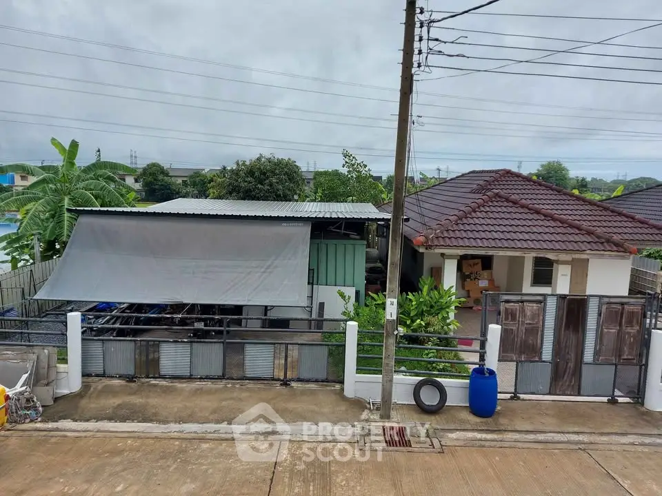 Charming suburban house with tiled roof and lush greenery, perfect for family living.