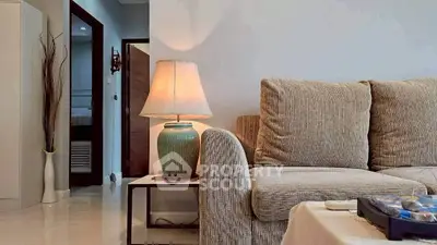 Cozy living room with elegant sofa and stylish lamp, perfect for relaxation.