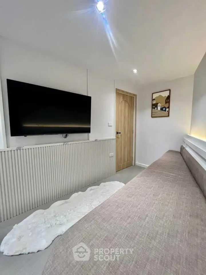 Modern living room with sleek TV and cozy seating area