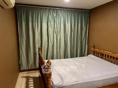 Cozy bedroom with wooden bed frame and elegant curtains in a warm-toned interior.