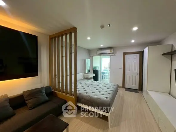 Modern studio apartment with cozy living area and stylish partition