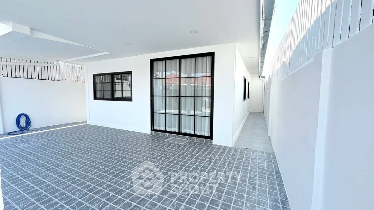 Modern minimalist exterior with sleek white walls and large windows, perfect for contemporary living.