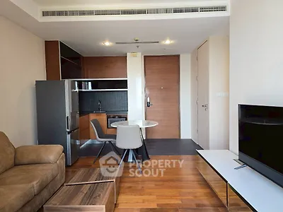 Modern living room with sleek furniture and open kitchen layout