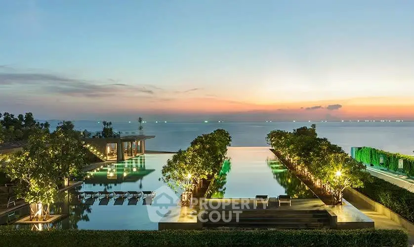 Luxurious infinity pool with stunning ocean view at sunset, perfect for relaxation and leisure.