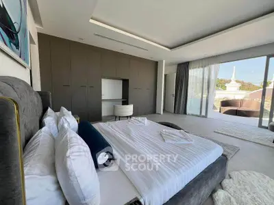 Luxurious bedroom with modern design and large windows offering stunning views.
