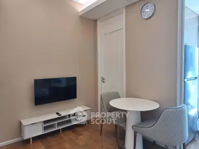 Modern living room with sleek TV setup and cozy dining area