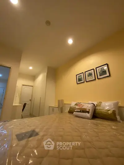 Cozy bedroom with modern decor and soft lighting, perfect for relaxation.