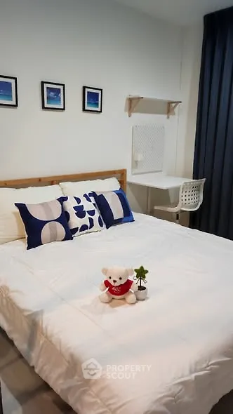 Cozy bedroom with modern decor and plush bedding, perfect for relaxation.