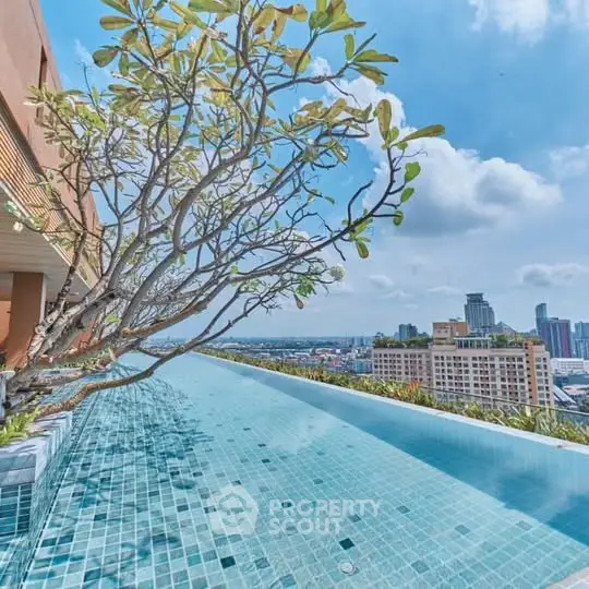 Stunning rooftop pool with panoramic city views and lush greenery.