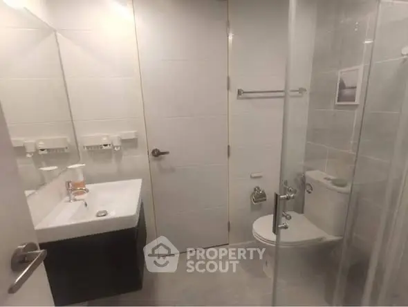 Modern bathroom with sleek fixtures and glass shower enclosure