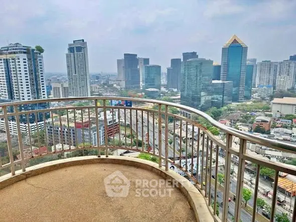 Stunning cityscape view from a high-rise balcony overlooking urban skyline.