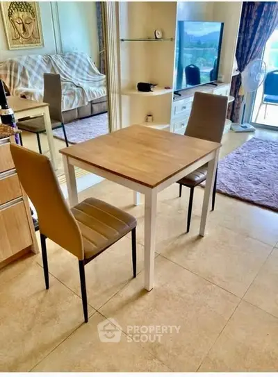 Cozy living room with dining area and balcony view, perfect for modern living.