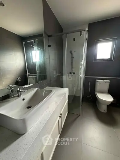 Modern bathroom with sleek fixtures and glass shower enclosure