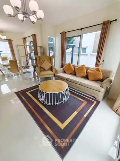 Spacious living room with modern decor and large windows for natural light.