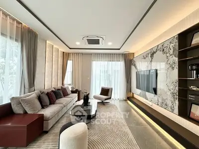 Luxurious modern living room with elegant decor and large windows.