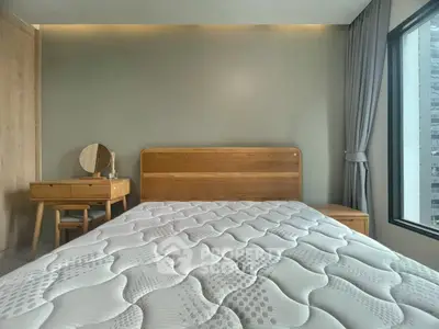 Modern bedroom with wooden furniture and large window view