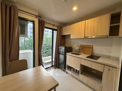 Modern kitchen with open layout and balcony view in urban apartment